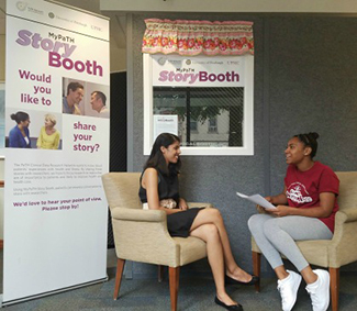 Story Booth participant talks with a PaTH student worker